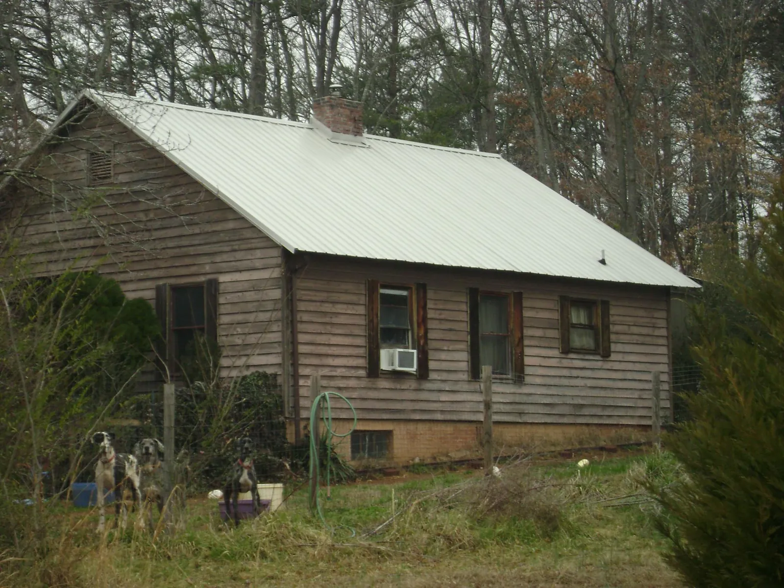 White metal roof on an old wood sided farmhouse, from a Asphalt Shingle Roof Repair job in New Salem